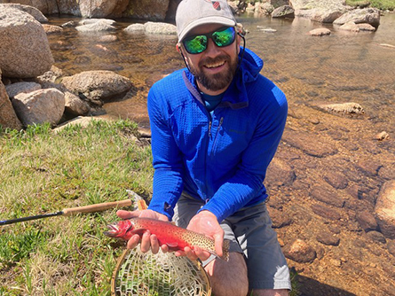 Joel York Holds a Fish He Caught